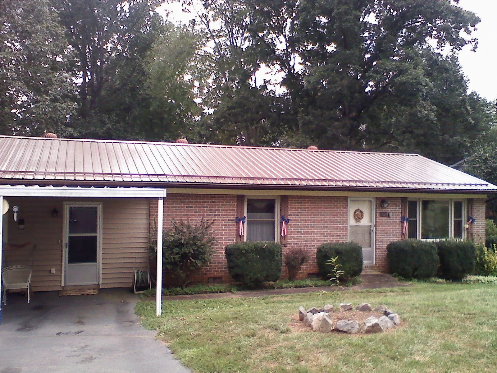 Bronze metal roof and carport on a brick ranch home — Roof Repair work by our crew in Cibolo